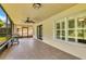 Covered and screened lanai with tile flooring, ceiling fan, and grill, creating a relaxing outdoor space at 561 Vineyard Way, Poinciana, FL 34759