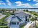 An aerial shot shows a modern home with a dark roof, two-car garage, and well-maintained landscaping at 5708 Emerington Cres, Orlando, FL 32819