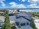 An aerial view of a luxury home featuring a screened pool, a three-car garage, and beautiful landscaping at 5708 Emerington Cres, Orlando, FL 32819