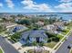 An aerial view of a lakeside neighborhood featuring modern homes, lush landscaping, and scenic water views at 5708 Emerington Cres, Orlando, FL 32819