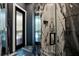 This bathroom features modern marble tile with glass-enclosed shower and sleek fixtures at 5708 Emerington Cres, Orlando, FL 32819