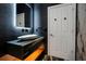 Powder room featuring unique vanity with vessel sink and modern fixtures at 5708 Emerington Cres, Orlando, FL 32819