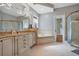 Spacious bathroom with a tub, tiled floors, granite countertops, and a glass door shower at 5708 Emerington Cres, Orlando, FL 32819