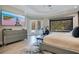 Modern bedroom with a large tv, dresser, work-out bike and a view to the pool area at 5708 Emerington Cres, Orlando, FL 32819