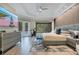 Modern bedroom with a large tv, dresser, work-out bike, view to the outside at 5708 Emerington Cres, Orlando, FL 32819