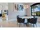 Modern dining area with round table, comfortable chairs, and natural light from the window at 5708 Emerington Cres, Orlando, FL 32819