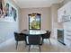 Modern dining area with round table, comfortable chairs, modern chandelier and white bar at 5708 Emerington Cres, Orlando, FL 32819
