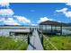 A covered boat dock extends into the lake, providing a shady spot for relaxing by the water at 5708 Emerington Cres, Orlando, FL 32819