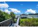 A peaceful lakeside view from the dock, featuring a covered gazebo and serene water at 5708 Emerington Cres, Orlando, FL 32819