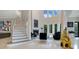 Elegant foyer boasts a staircase, high windows for abundant light, fireplace, and unique decorative elements at 5708 Emerington Cres, Orlando, FL 32819