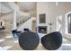 Grand foyer with a curved staircase, soaring ceilings, modern fireplace, and stylish seating at 5708 Emerington Cres, Orlando, FL 32819