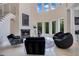 Bright foyer features a fireplace, statement artwork, high windows, and unique decor at 5708 Emerington Cres, Orlando, FL 32819