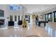 Spacious foyer boasts a fireplace, unique artwork, pool table, and high windows providing ample light at 5708 Emerington Cres, Orlando, FL 32819