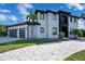 View of a modern two-story home with patterned driveway, and a two-car garage at 5708 Emerington Cres, Orlando, FL 32819