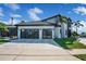 View of a modern two-story home with patterned driveway, and a two-car garage at 5708 Emerington Cres, Orlando, FL 32819