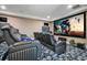 Enjoy movie nights in this home theater with reclining seats and a large screen at 5708 Emerington Cres, Orlando, FL 32819