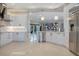Bright kitchen with modern white cabinetry, stainless steel appliances, and marble countertops at 5708 Emerington Cres, Orlando, FL 32819