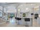Modern kitchen with breakfast bar, dining area, stainless steel appliances, staircase and sight lines to the game room at 5708 Emerington Cres, Orlando, FL 32819