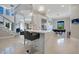 Bright, modern kitchen with breakfast bar, dining area, stainless steel appliances, and staircase in an open-concept design at 5708 Emerington Cres, Orlando, FL 32819