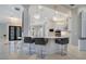 Stylish kitchen featuring a breakfast bar with seating, modern pendant lights, and sight lines to the foyer at 5708 Emerington Cres, Orlando, FL 32819