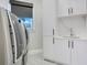 Convenient laundry room with washer, dryer, sink, and ample storage space at 5708 Emerington Cres, Orlando, FL 32819