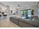 A spacious living room features tile floors, modern decor, and sliding glass doors to the pool area at 5708 Emerington Cres, Orlando, FL 32819
