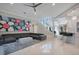 A spacious living room features tile floors, modern decor, with an open floor plan to the kitchen at 5708 Emerington Cres, Orlando, FL 32819