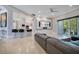 Open-concept living area featuring sleek bar seating, a modern entertainment center, and access to outdoor living at 5708 Emerington Cres, Orlando, FL 32819