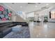 A spacious living room features tile floors, modern decor, with an open floor plan to the kitchen and stairway at 5708 Emerington Cres, Orlando, FL 32819