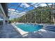 A beautiful pool, spa, and seating inside of a screened in pool area at 5708 Emerington Cres, Orlando, FL 32819