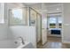 Bathroom with soaking tub and glass-enclosed shower, adjacent to a bedroom at 7206 Nottingham Reel Ct, St Cloud, FL 34773