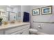 Well-lit bathroom featuring granite countertops, white cabinetry and nautical decorations at 7206 Nottingham Reel Ct, St Cloud, FL 34773