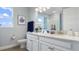 Bright bathroom featuring double sinks, white cabinetry, and granite countertops at 7206 Nottingham Reel Ct, St Cloud, FL 34773