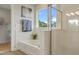 Bathroom featuring a tub and glass shower with white tile and neutral walls at 7206 Nottingham Reel Ct, St Cloud, FL 34773