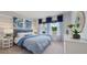 Cozy bedroom with large windows, stylish decor, and a comfortable bed at 7206 Nottingham Reel Ct, St Cloud, FL 34773