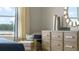 Bedroom features a dresser with decor, an accent chair, and a view from the window at 7206 Nottingham Reel Ct, St Cloud, FL 34773