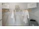 Walk-in closet with white wire shelving, filled with white linens and branded shopping bags at 7206 Nottingham Reel Ct, St Cloud, FL 34773