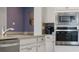 Close-up of a modern kitchen with stainless steel appliances and granite countertops at 7206 Nottingham Reel Ct, St Cloud, FL 34773