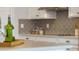 Bright kitchen with granite countertops, white cabinets, and decorative tile backsplash at 7206 Nottingham Reel Ct, St Cloud, FL 34773