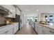 Spacious kitchen with stainless steel appliances, granite countertops, and adjacent dining area at 7206 Nottingham Reel Ct, St Cloud, FL 34773