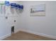 Bright laundry room with shelving, clean lines, and wood-look flooring at 7206 Nottingham Reel Ct, St Cloud, FL 34773