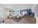 Spacious living room with plush seating and scenic views from large windows at 7206 Nottingham Reel Ct, St Cloud, FL 34773