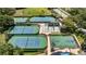 Aerial view of community tennis courts, basketball court, and racquetball court with lush landscaping at 7237 Woodville Cres, Orlando, FL 32819