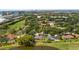 An aerial view of the property with a pond, lush greenery, and city skyline in the distance at 7237 Woodville Cres, Orlando, FL 32819