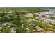 An aerial view showing the property near a golf course, baseball field, and beautiful green surroundings at 7237 Woodville Cres, Orlando, FL 32819