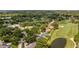 Aerial view of property highlighting golf course, pond, and lush surroundings at 7237 Woodville Cres, Orlando, FL 32819