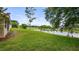 Expansive backyard with lush green lawn, pond, and golf course views at 7237 Woodville Cres, Orlando, FL 32819