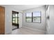 Bedroom with sliding door access to screened lanai overlooking water view at 7237 Woodville Cres, Orlando, FL 32819