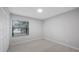 Clean and minimal bedroom featuring hardwood floors and a bright window at 7237 Woodville Cres, Orlando, FL 32819