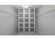 Spacious walk-in closet with built-in shelving and ample storage space behind glass doors at 7237 Woodville Cres, Orlando, FL 32819